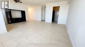 Toronto (Yorkdale-Glen Park) condo for rent - A spacious living room with a flat screen TV and a ceiling fan.