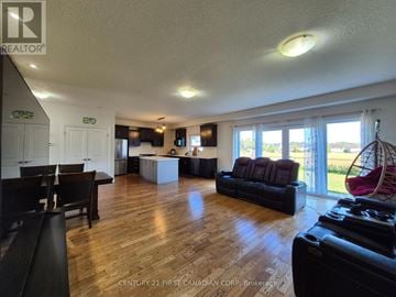 London North (North D) apartment for rent - A living room with a black couch and a wooden floor.