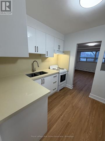 Toronto (Lansing-Westgate) multi-family for rent - A kitchen with white cabinets and a sink.