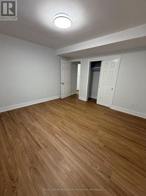 Toronto (Lansing-Westgate) multi-family for rent - A room with wooden flooring and white walls.