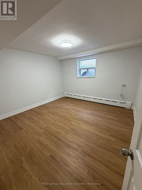 Toronto (Lansing-Westgate) multi-family for rent - A room with wooden flooring and a window.