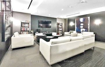 Toronto (Niagara) condo for rent - A modern living room with a white sofa and a television.