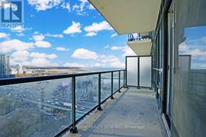 Toronto (Niagara) condo for rent - A balcony with a glass railing overlooking a cityscape.