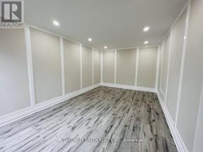 Ajax (Central) apartment for rent - A room with wooden flooring and white walls.