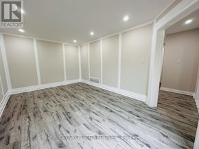 Ajax (Central) apartment for rent - A room with wooden flooring and white walls.