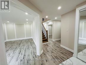 Ajax (Central) apartment for rent - A spacious room with wooden flooring and a staircase leading to another room.