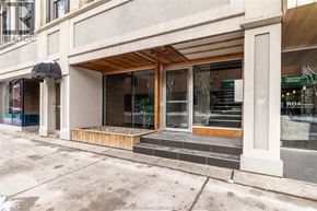 Chatham apartment for rent - A building with a Realty storefront has a black awning and a wooden deck.