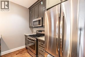 Chatham apartment for rent - A kitchen with a stainless steel refrigerator, microwave, and oven.