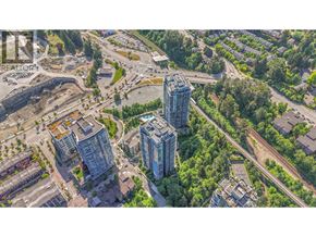 Port Moody apartment for rent - A construction site is surrounded by trees and residential buildings.