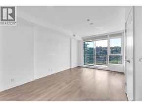 Port Moody apartment for rent - A spacious room with a sliding glass door leading to a view of trees and houses.