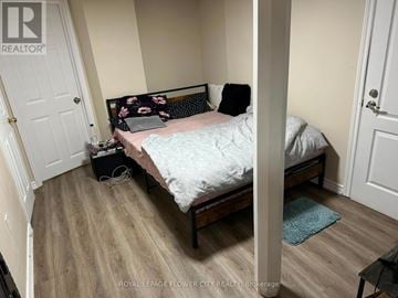 Mississauga (Hurontario) apartment for rent - A bedroom with a bed, pillows, and a laptop on the bed.
