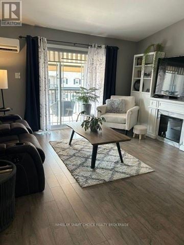 Cornwall condo for rent - A living room with a white couch and a wooden coffee table.
