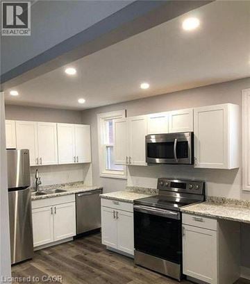 Hamilton apartment for rent - A kitchen with white cabinets and stainless steel appliances.
