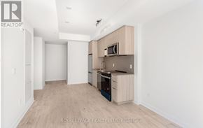 Milton (Cb Cobban) condo for rent - A kitchen with a microwave above the stove and a counter.