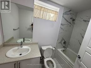 Bradford West Gwillimbury (Bradford) apartment for rent - A bathroom with a sink, toilet, and shower.