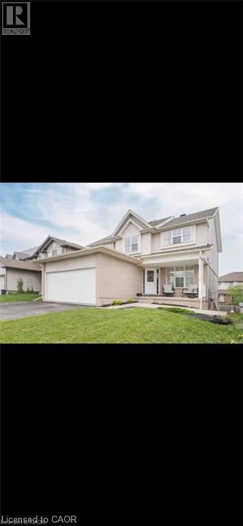 Guelph apartment for rent - A large, two-story house with a garage is shown.