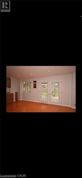 Guelph apartment for rent - A room with white walls and wooden flooring.