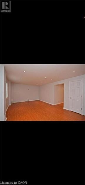 Guelph apartment for rent - A room with wooden flooring and white walls.
