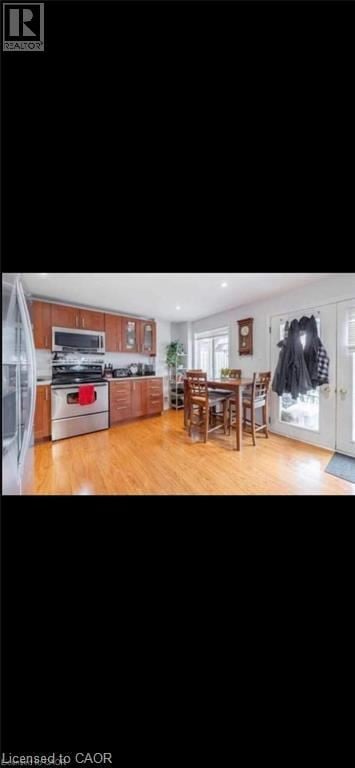 Guelph apartment for rent - A kitchen with wooden cabinets and a black refrigerator.