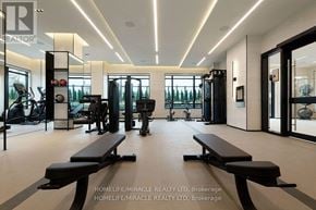 Toronto (Etobicoke West Mall) condo for rent - A gym with a row of benches in the middle of the room.