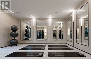 Toronto (Etobicoke West Mall) condo for rent - A spacious hallway with mirrors on the wall and a sculpture on the floor.