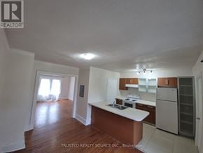 Windsor multi-family for rent - A kitchen with a white counter top and wooden floors.