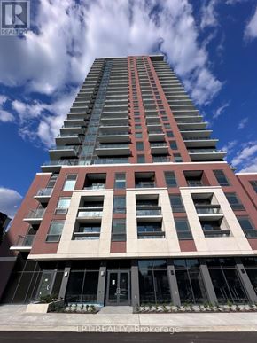 Toronto (Humber Heights) condo for rent - A tall building with a red and beige facade stands under a blue sky with clouds.