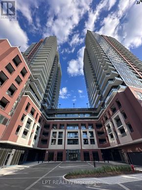 Toronto (Humber Heights) condo for rent - A modern building complex with a clear blue sky above.