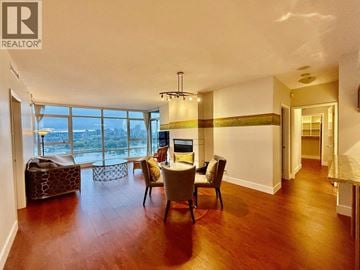 Vancouver apartment for rent - A living room with a couch, chairs, and a table with a laptop on it.