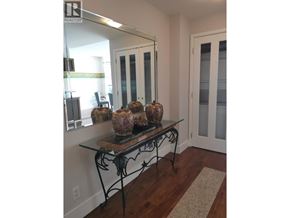 Vancouver apartment for rent - A table with vases on it in a room.