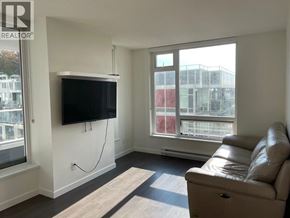 Vancouver apartment for rent - A living room with a leather couch and a flat screen TV mounted on the wall.
