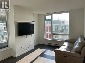 Vancouver apartment for rent - A living room with a leather couch and a flat screen TV mounted on the wall.