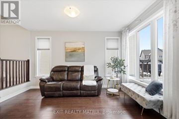 Russell townhouse for rent - A living room with a brown leather couch and a white sofa bed.