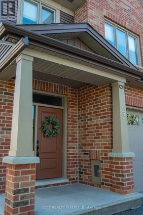 Russell townhouse for rent - A house with a brown door and a wreath on it.