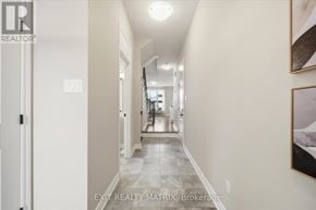 Russell townhouse for rent - A hallway with a door on the left and a painting on the right.