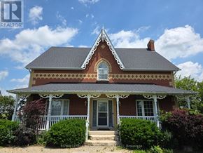 Caledon apartment for rent - A Victorian style house with a grey roof and a white porch.