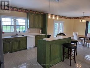 Caledon apartment for rent - A kitchen with green cabinets and a white dishwasher.