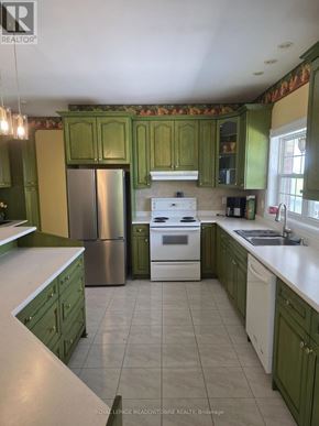 Caledon apartment for rent - A kitchen with green cabinets and a stainless steel refrigerator.
