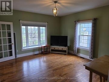 Caledon apartment for rent - A living room with a television and a wooden floor.