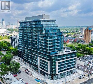 Mississauga (Cooksville) condo for rent - A tall building with many windows is under construction.