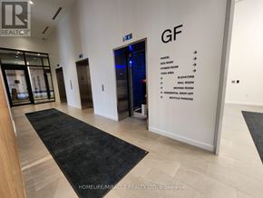 Mississauga (Cooksville) condo for rent - A hallway with a sign that lists the amenities available in the building.