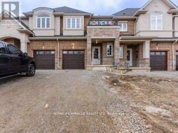 Hamilton (Hill Park) townhouse for rent - A black car is parked in front of a two-story house with a gravel driveway.