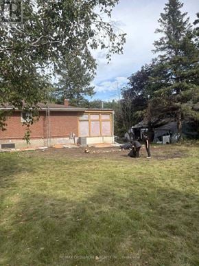 Clarington apartment for rent - A person is working on a construction site in a backyard.
