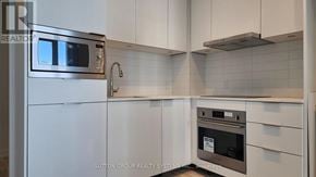 Toronto (Newtonbrook East) condo for rent - A modern kitchen with a stainless steel refrigerator and oven.