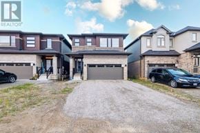 Brantford apartment for rent - A real estate listing photo shows a two-story house with a garage.