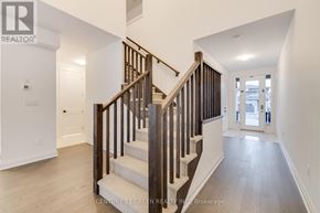 Brantford apartment for rent - A wooden staircase with white risers leads to a second floor.