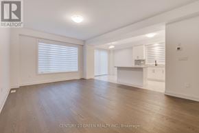 Brantford apartment for rent - A spacious room with wooden flooring and white walls.