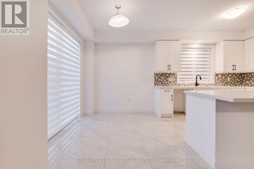Brantford apartment for rent - A kitchen with white cabinets and a countertop.