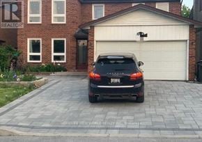 Toronto (Bayview Village) apartment for rent - A black car is parked in front of a garage.