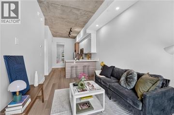 Hamilton apartment for rent - A modern living room with a grey couch and a white coffee table.